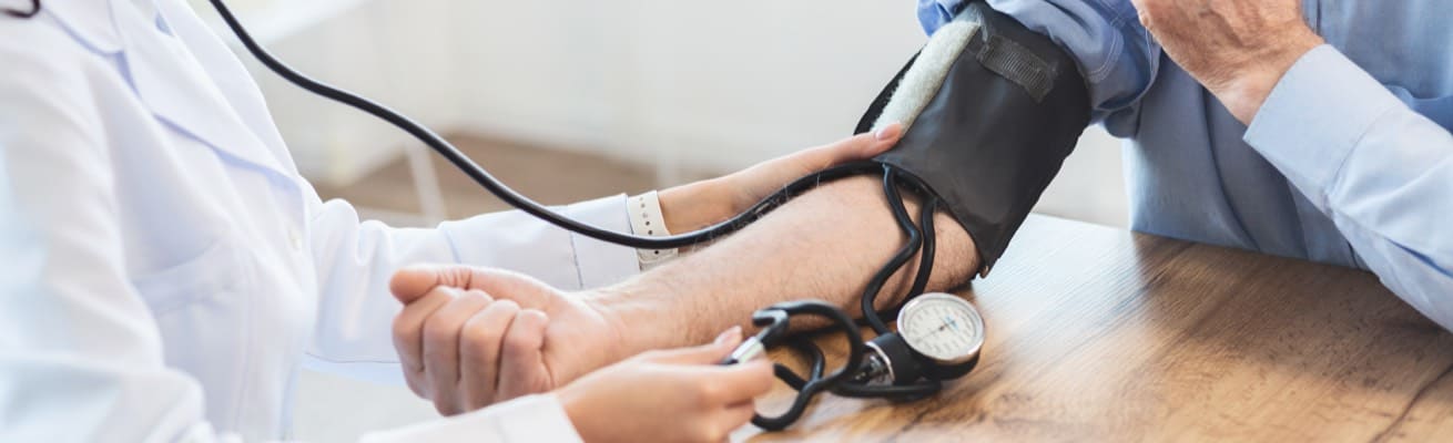 Close-up of a nurse taking a patient's heart rate.